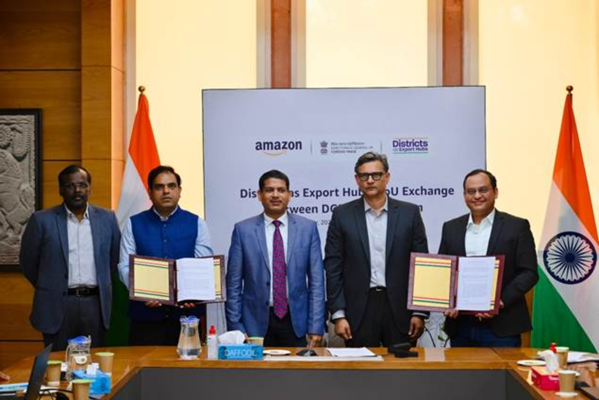 Representatives from DGFT and Amazon signing the MoU
