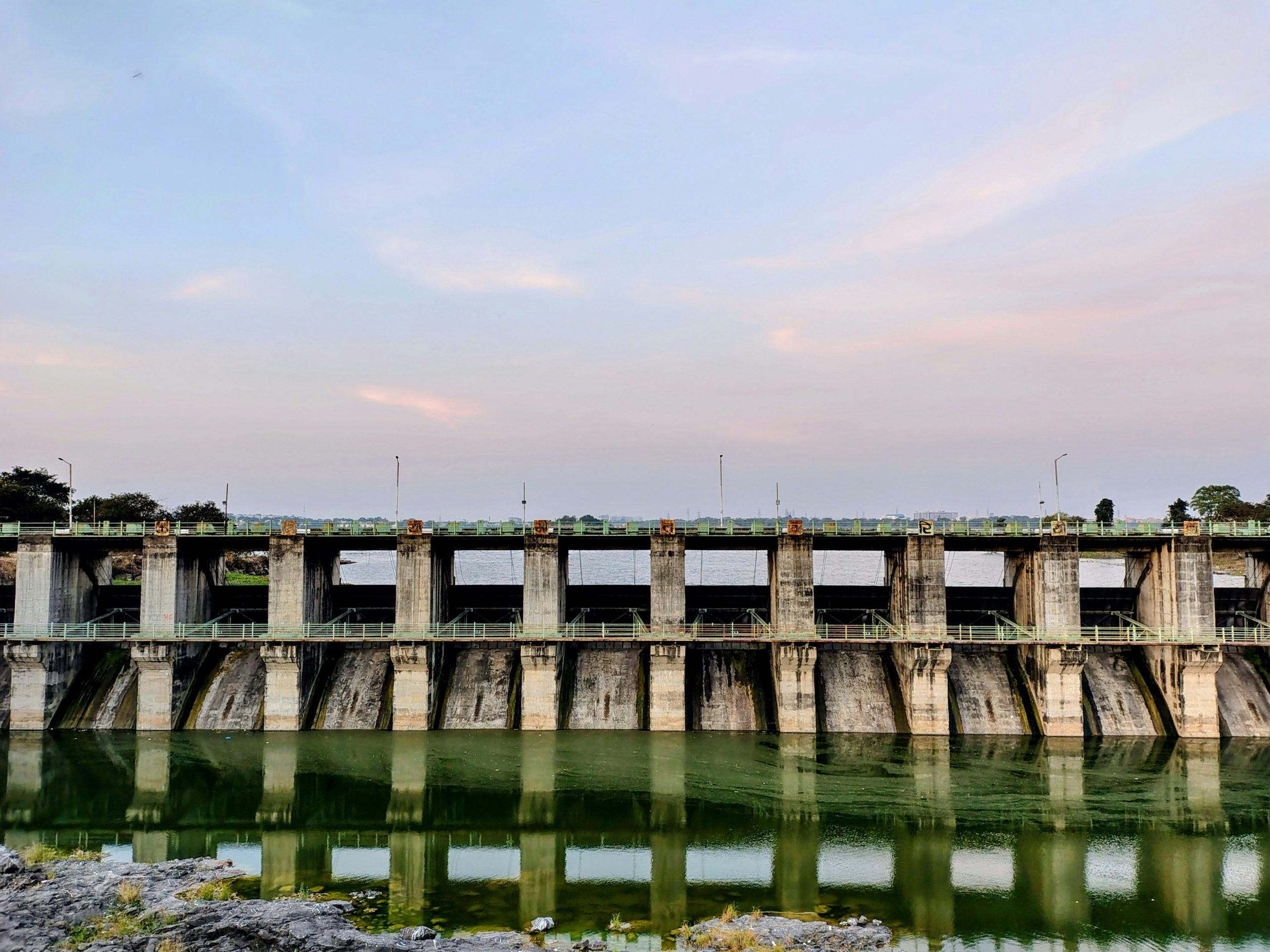A concrete dam holding back a river reservoir