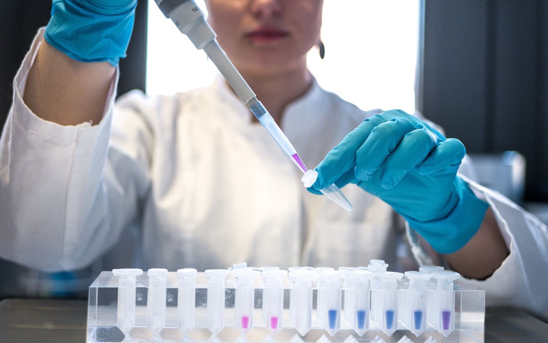A scientist working with vials in a vaccine research laboratory