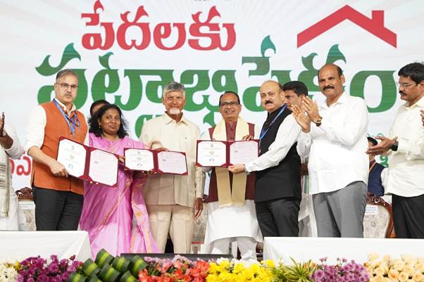 Shivraj Singh Chouhan and Chandrababu Naidu with housing documents at the PMAY-G event in Burripalem, Guntur